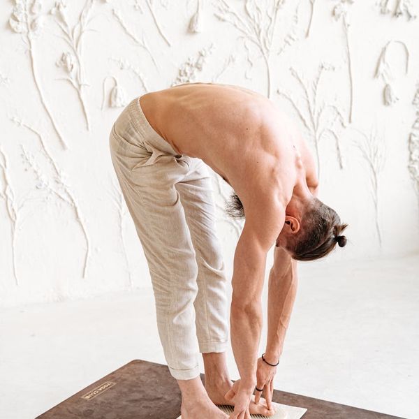 Man stretching gently, showing the benefits of regular practice.